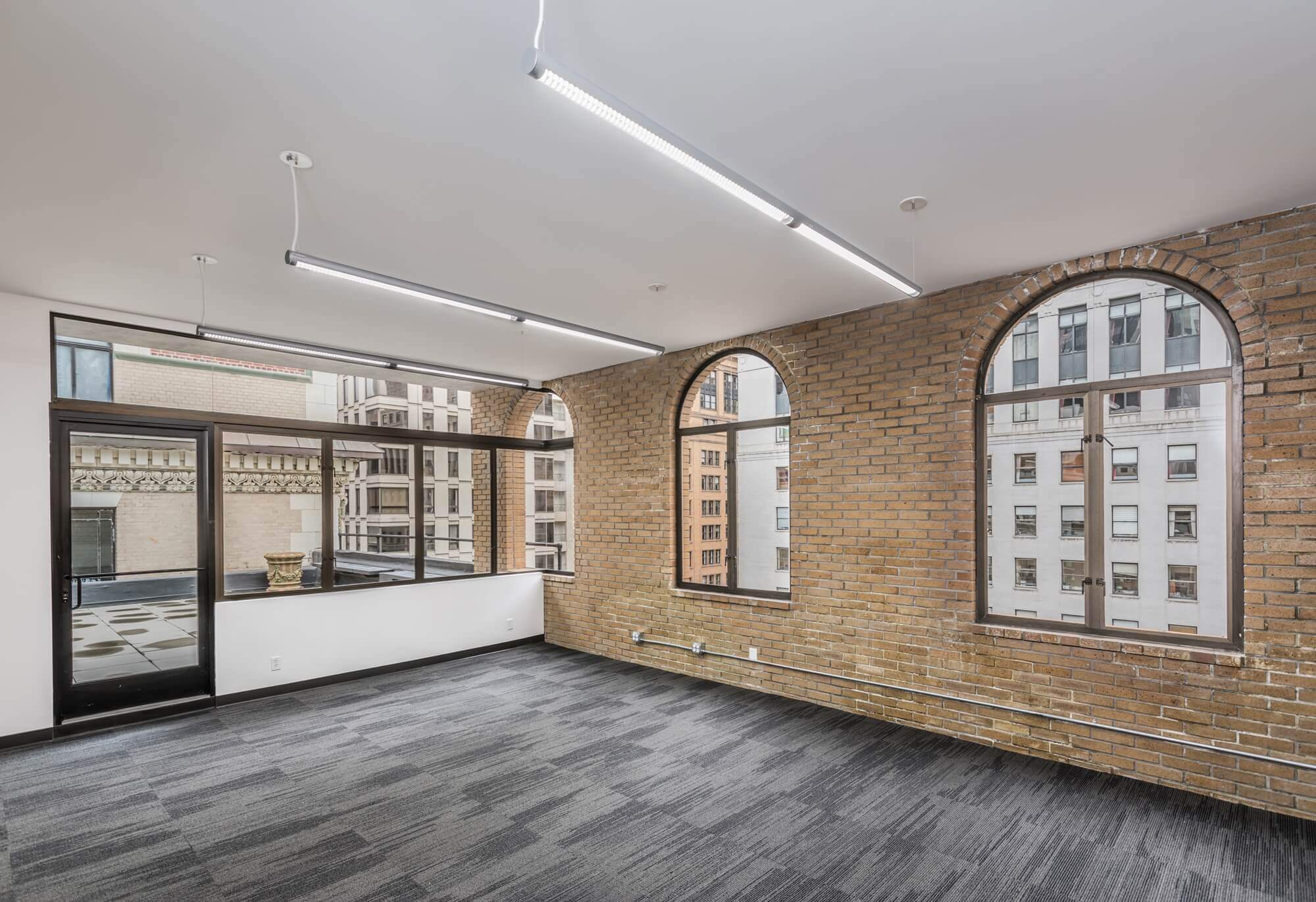 The Athletics san francisco office with a large room with wooden flooring and large glass window and a glass door