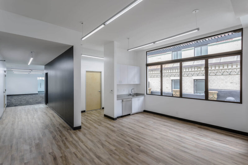 The Athletics san francisco office having a large room with wooden flooring and large glass window