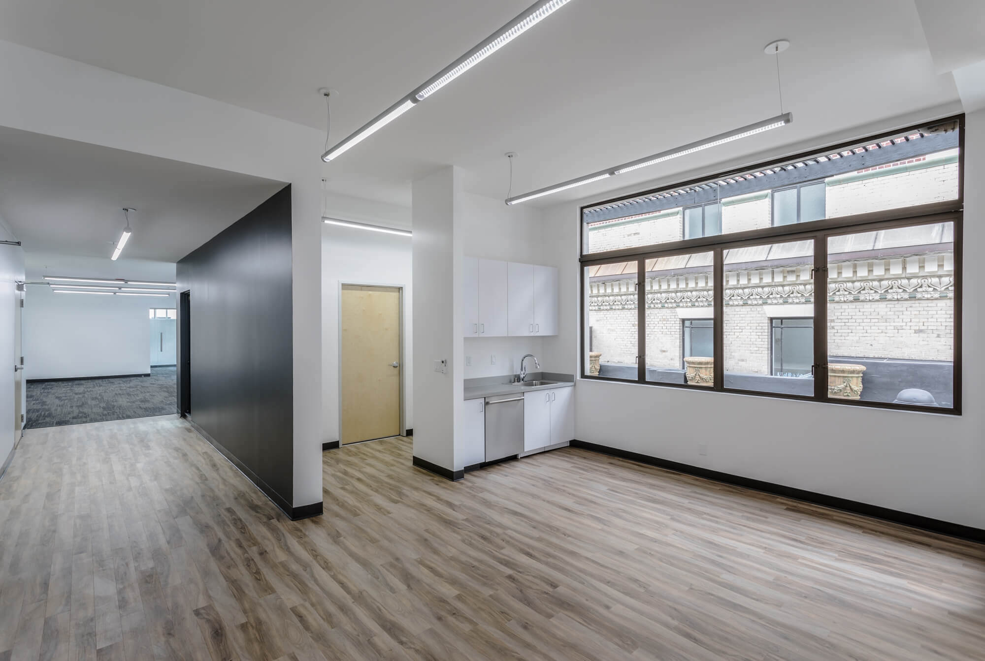 The Athletics san francisco office having a large room with wooden flooring and large glass window