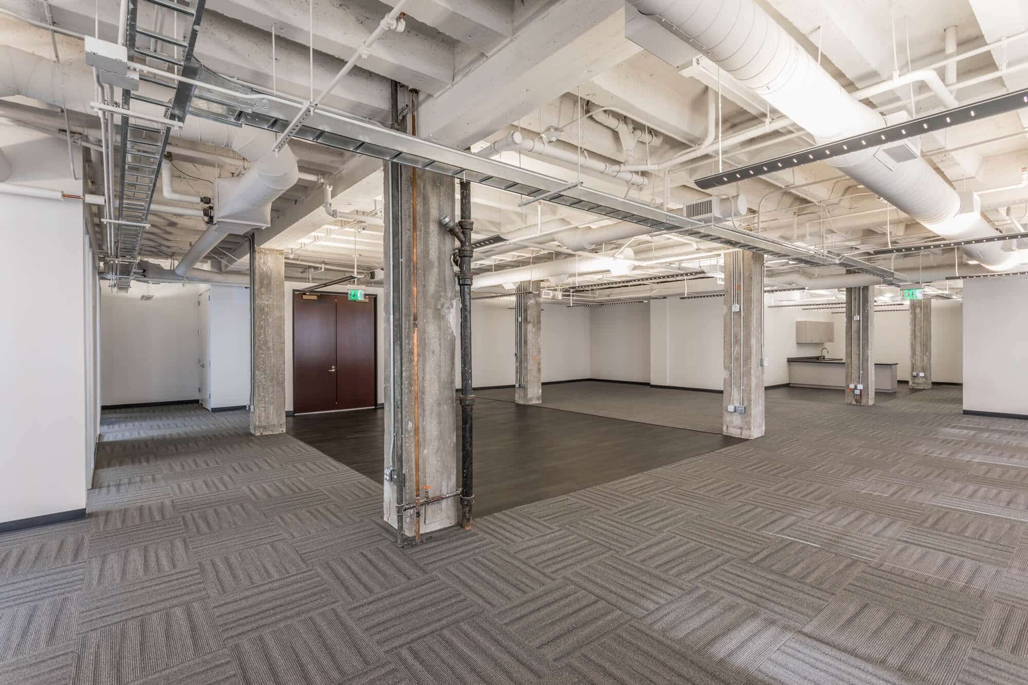 a large room with concrete pillars