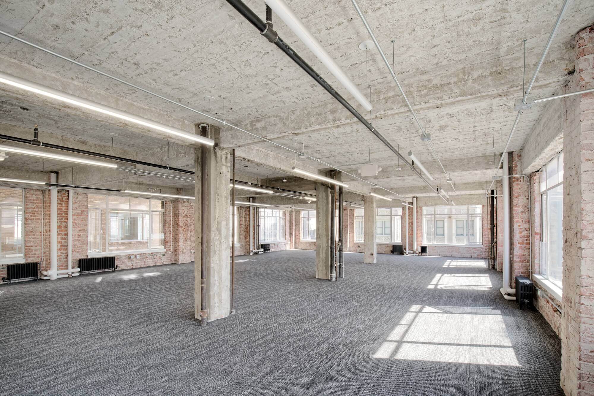 open office space renovation with lighting and glass windows