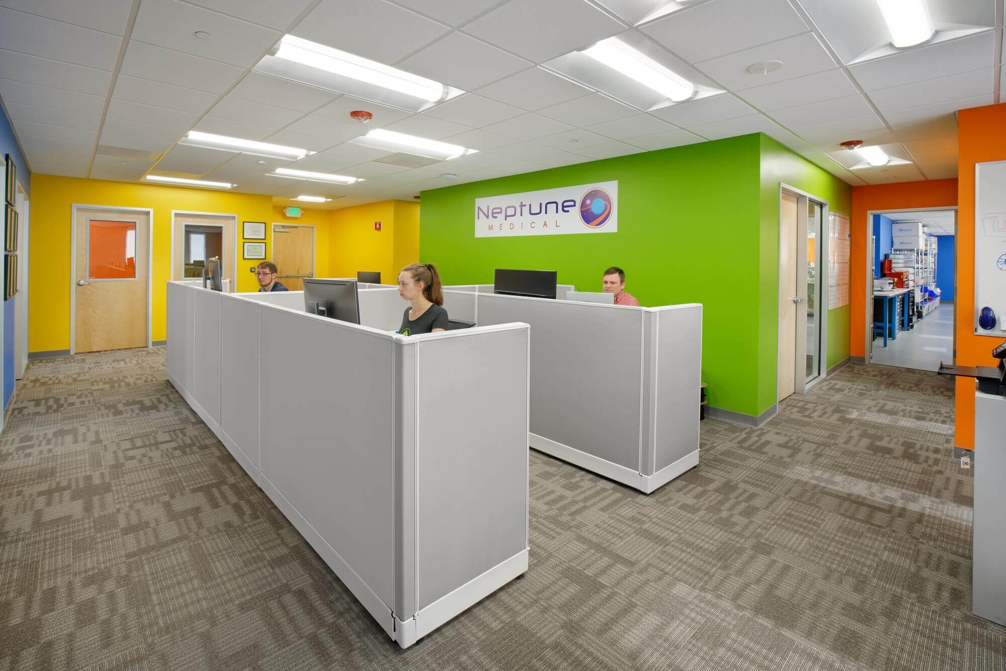 Neptune Medical co-workers working in open space renovated office