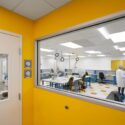 Neptune Medical facility renovation - yellow colored wall with large glass window