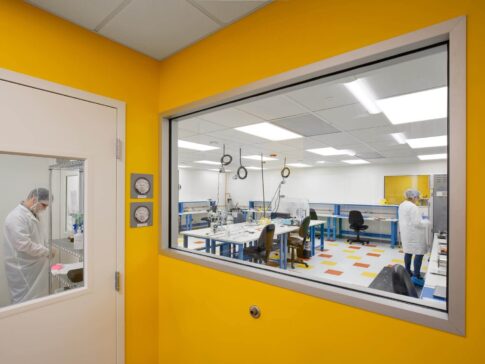 Neptune Medical facility renovation - yellow colored wall with large glass window