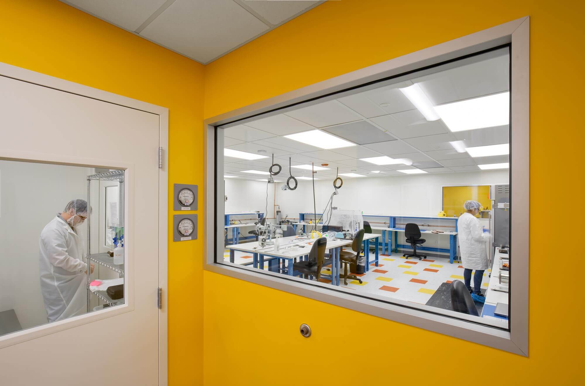 Neptune Medical facility renovation - yellow colored wall with large glass window