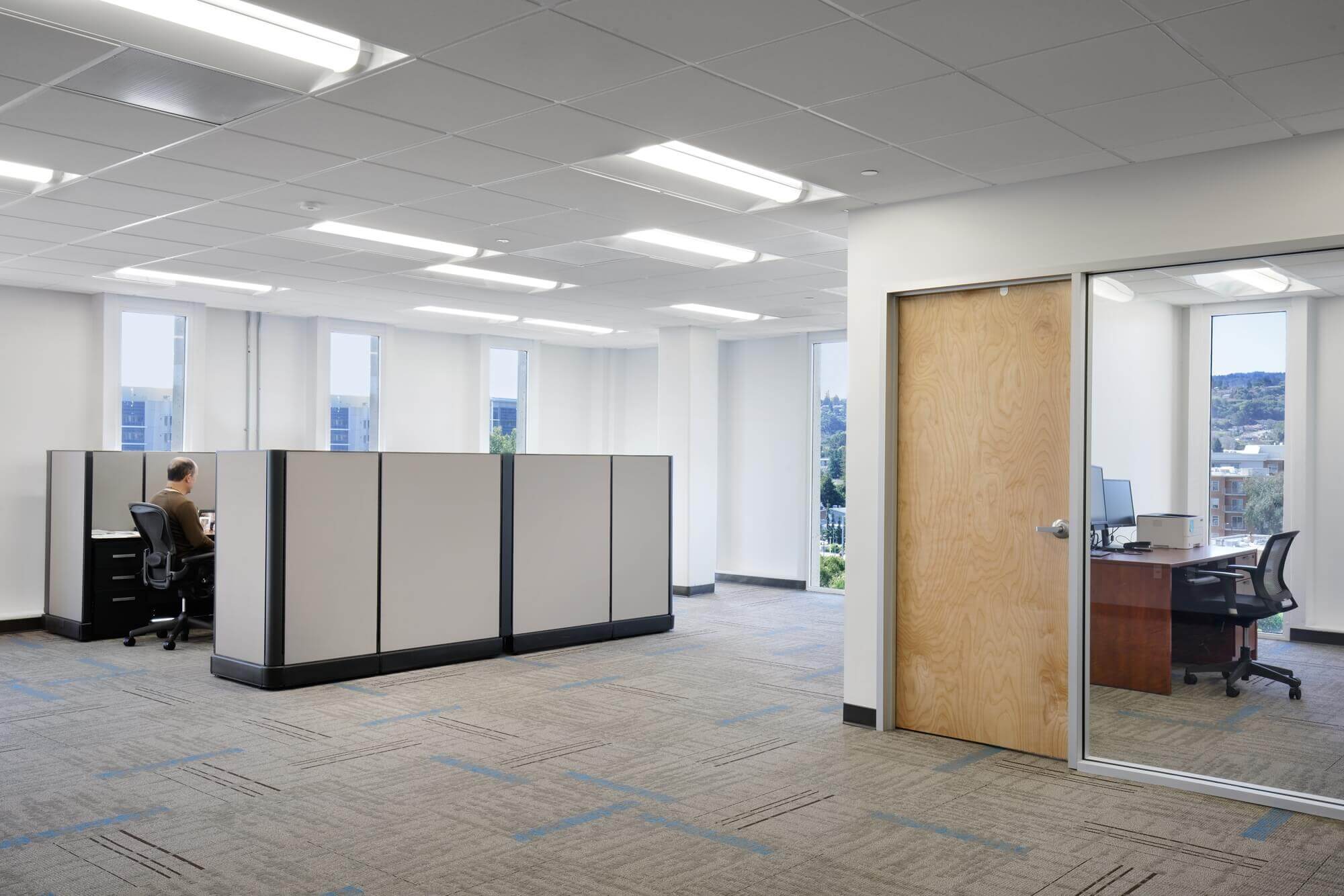 Respira Therapeutics open space office construction with wooden door and large glass window
