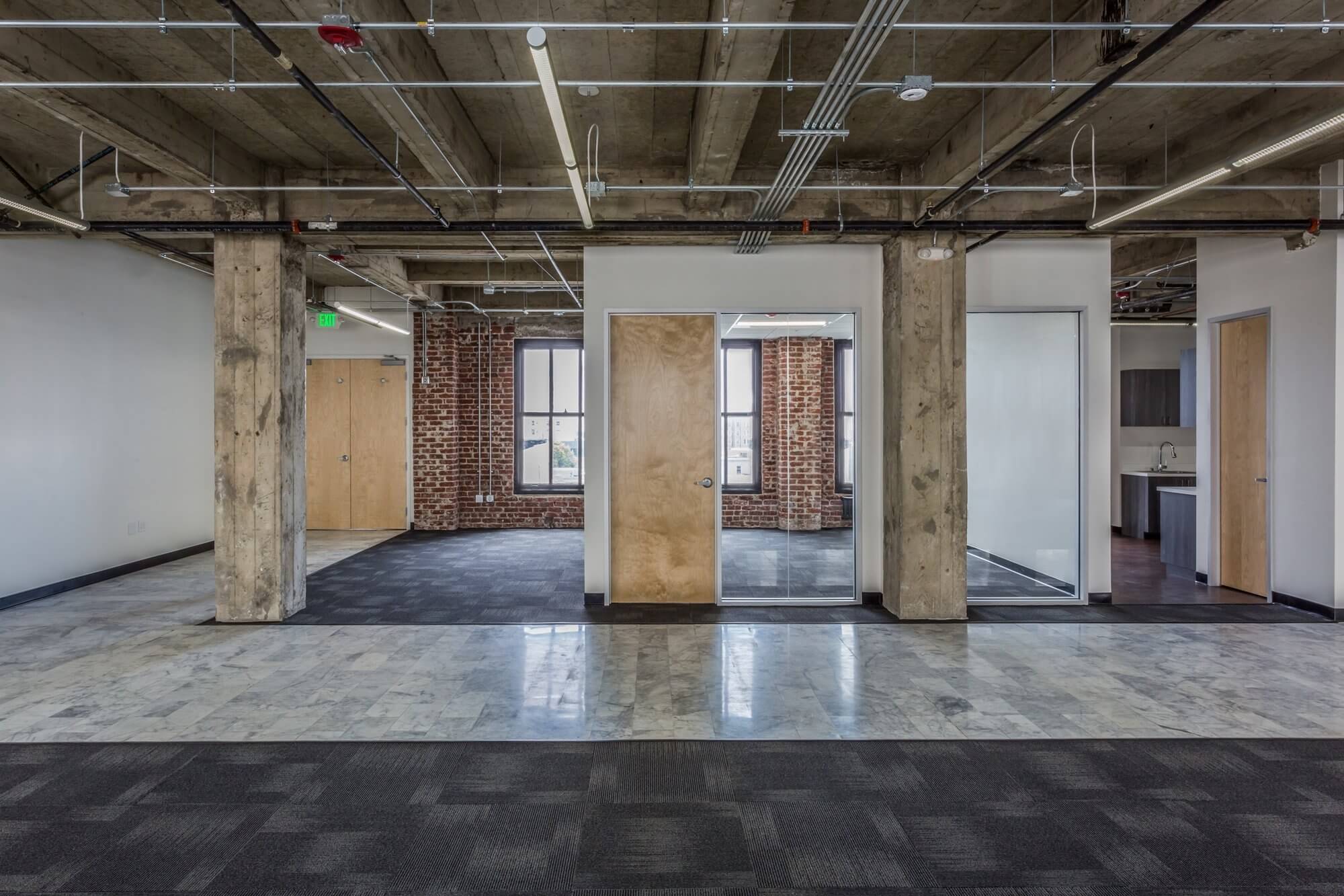 office space with pillar and brown door