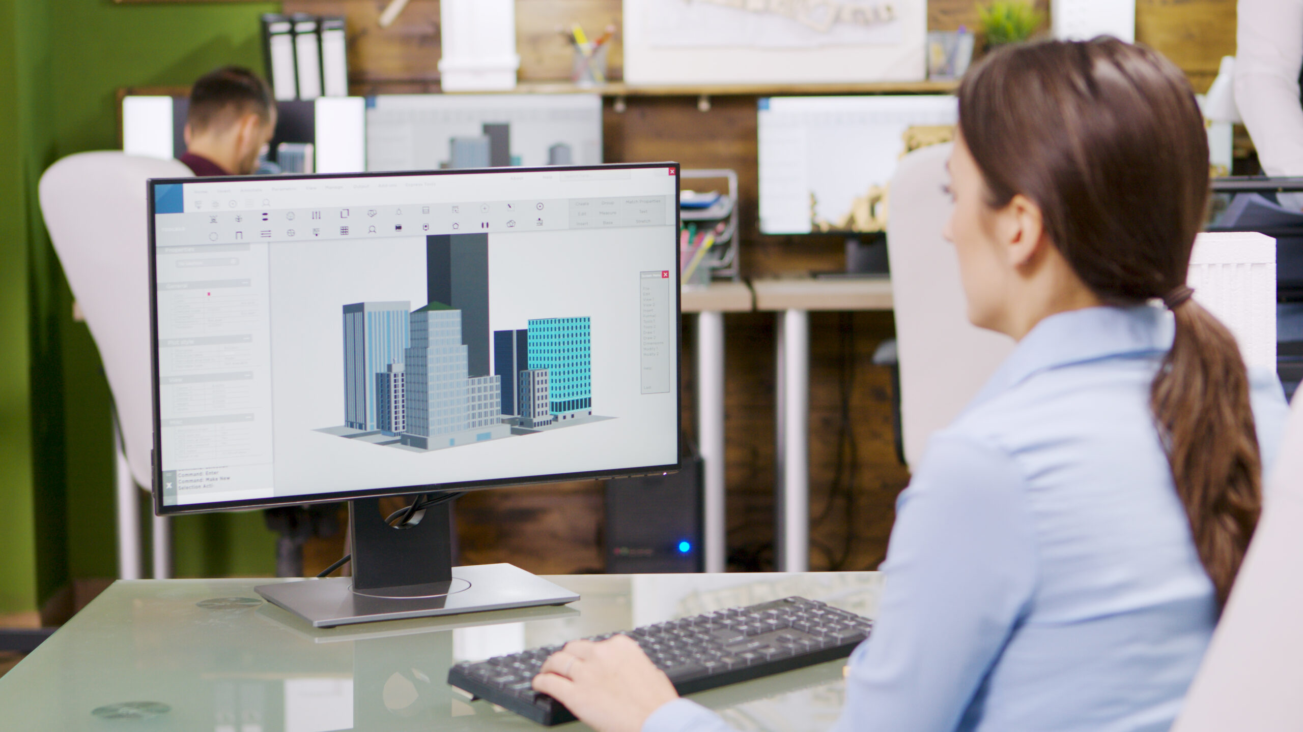 Female architect making 3d BIM models on computer.