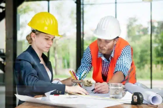 construction workers discussing construction layout construction workers discussing construction layout