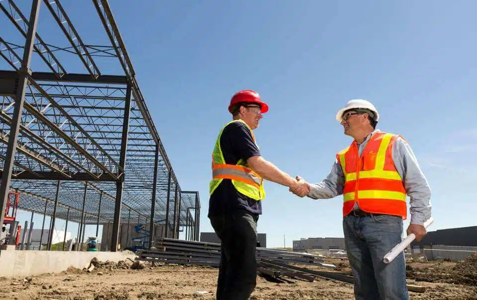 2 general contractors shaking hands at construction site in bay area san francisco