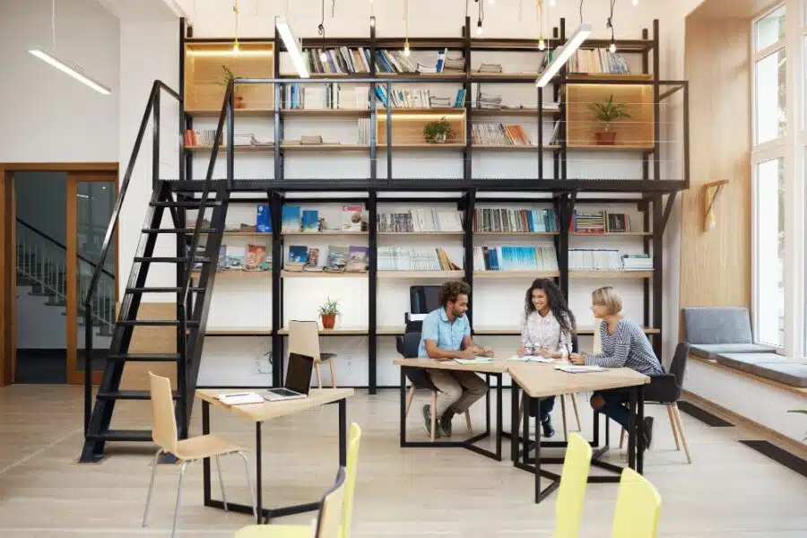 employees in a commercial office sitting on chairs with a table
