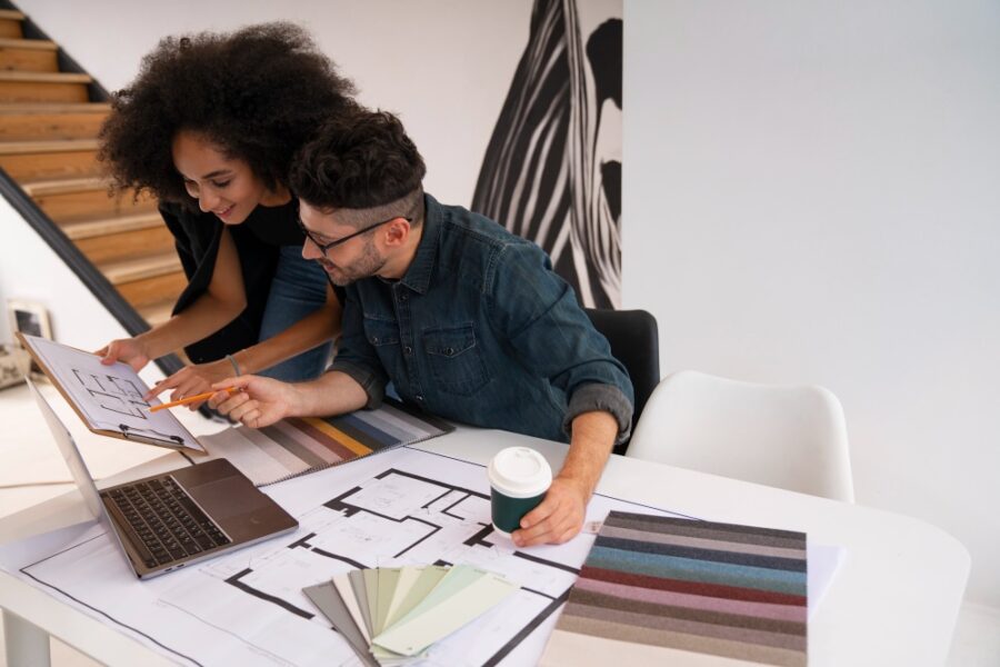 two construction employees working on a renovation blueprint