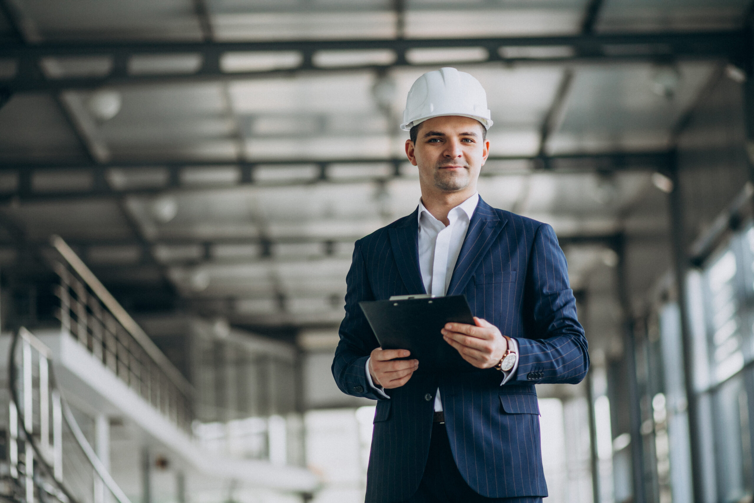 A construction project manager in hard hat in a building