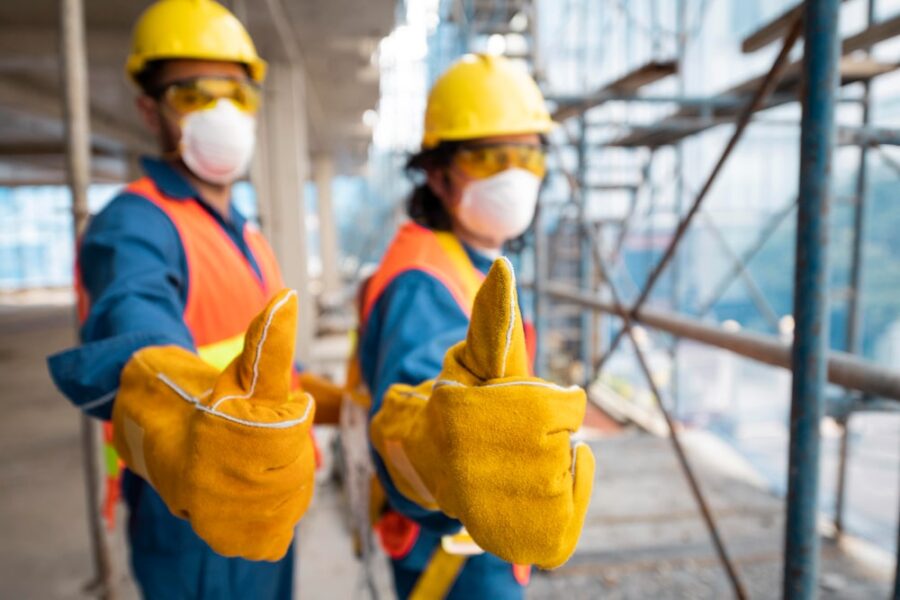 two construction workers giving thumbs up