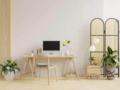 Home office room with white colored walls and cream colored furniture. 