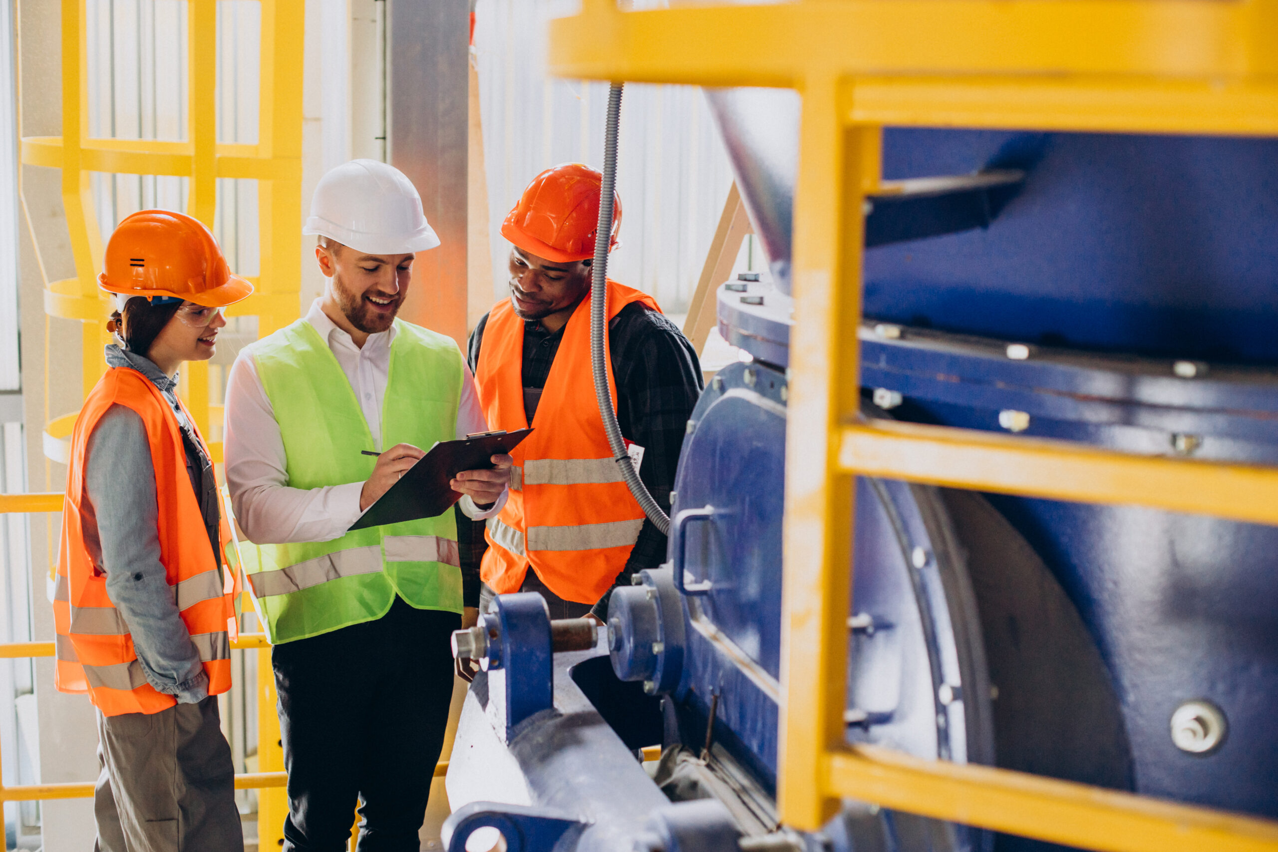 Three construction workers discussing industrial building plan and looking at a list of services.