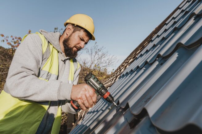 Repairman fixing a leaking roof