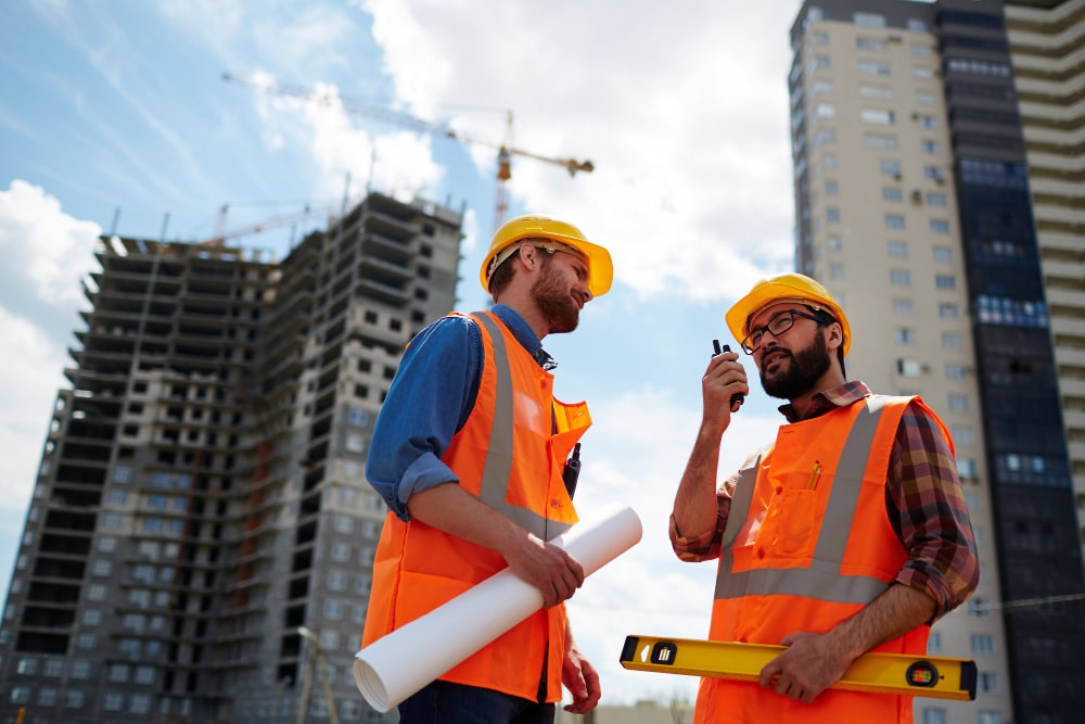 contractor and a worker discussing before a site