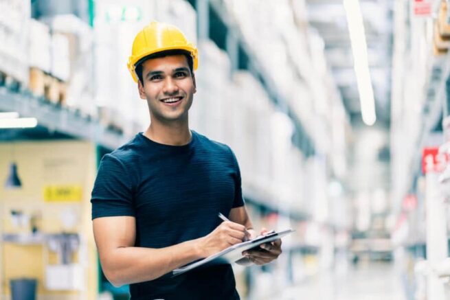 A picture of a retail general contractor holding a writing pad and a pen.